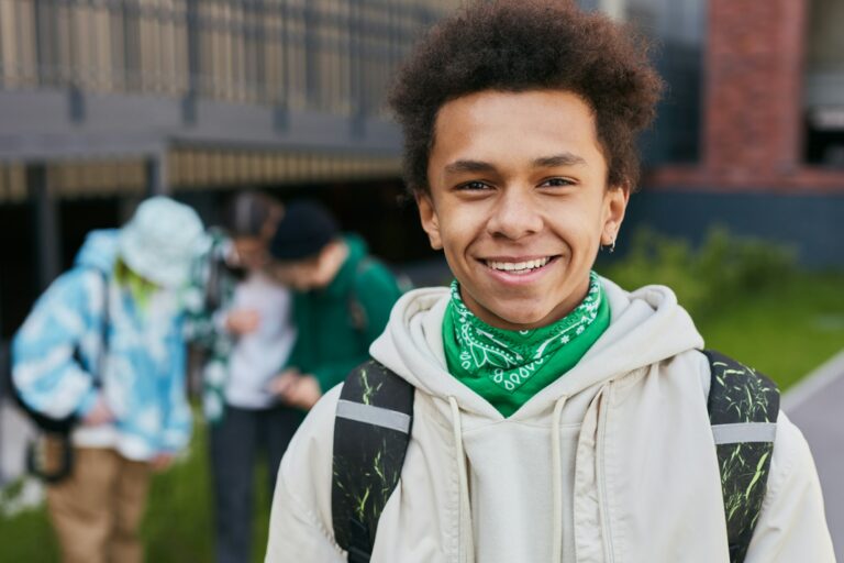 African teenage student standing outside